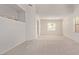 Spacious living room with neutral carpeting, high ceilings, and natural light at 7325 Perkins Hill St, Las Vegas, NV 89166