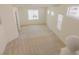 Bright living room with plush carpet and a large window, creating an inviting and spacious area at 7325 Perkins Hill St, Las Vegas, NV 89166