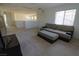 Spacious living room with neutral carpeting, modern furniture, and natural light at 7325 Perkins Hill St, Las Vegas, NV 89166