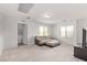 Upstairs living space featuring neutral carpet, comfortable seating, lots of natural light, and a laundry area at 7325 Perkins Hill St, Las Vegas, NV 89166