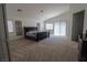 Large carpeted main bedroom featuring natural light, and vaulted ceilings at 7325 Perkins Hill St, Las Vegas, NV 89166