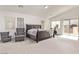 Spacious main bedroom showcasing neutral carpet, comfortable seating, and access to a private balcony at 7325 Perkins Hill St, Las Vegas, NV 89166