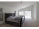 Spacious bedroom with vaulted ceilings, a dark wood bed frame, and ample natural light at 7325 Perkins Hill St, Las Vegas, NV 89166