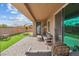 Charming covered patio features a cozy seating area and adjacent playset at 7616 Quail Dust St, North Las Vegas, NV 89084