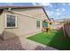 Wonderful backyard featuring a charming play structure and artificial grass for low maintenance at 7616 Quail Dust St, North Las Vegas, NV 89084