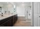 Modern bathroom with double vanity, soaking tub, and glass-enclosed shower, offering a luxurious and functional space at 7616 Quail Dust St, North Las Vegas, NV 89084