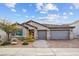 Charming single-story home featuring a tile roof, paver driveway, and a well-manicured front yard at 7616 Quail Dust St, North Las Vegas, NV 89084
