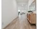 Bright hallway featuring wood-look tile flooring, a console table, and views into the living area at 7616 Quail Dust St, North Las Vegas, NV 89084