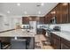 Gourmet kitchen boasting granite countertops, stainless steel appliances, and abundant dark wood cabinetry at 7616 Quail Dust St, North Las Vegas, NV 89084