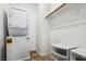 Convenient laundry area features a stacked washer and dryer with storage at 7616 Quail Dust St, North Las Vegas, NV 89084