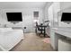 Well-lit main bedroom featuring a dedicated workspace and comfortable bed, perfect for relaxation and productivity at 7616 Quail Dust St, North Las Vegas, NV 89084