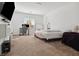 Spacious main bedroom with a dedicated desk area, carpet floors and a comfortable bed at 7616 Quail Dust St, North Las Vegas, NV 89084