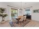 Bright dining room features modern light fixture, neutral paint and sliding glass doors to the backyard at 778 Horizon Canyon Dr, Henderson, NV 89052