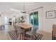 The light and airy dining room has wood-look tile floors, modern light fixtures, and glass doors to backyard at 778 Horizon Canyon Dr, Henderson, NV 89052