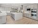 Modern kitchen offers stainless steel appliances, gray cabinets, a large island, and hardwood-style floors at 778 Horizon Canyon Dr, Henderson, NV 89052