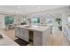 Open kitchen view featuring an island with a wine fridge, sink, white countertops, and hardwood-style flooring at 778 Horizon Canyon Dr, Henderson, NV 89052