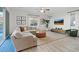 Spacious living room features light wood floors, a large sectional sofa, and a ceiling fan at 778 Horizon Canyon Dr, Henderson, NV 89052