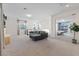 Bright living room featuring a gray sectional, neutral carpet and lots of natural light at 778 Horizon Canyon Dr, Henderson, NV 89052