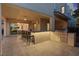 An outdoor kitchen with seating at the counter and a built in grill for entertaining with easy access to the home at 778 Horizon Canyon Dr, Henderson, NV 89052