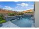 Luxury pool with waterfall feature and desert landscape at 778 Horizon Canyon Dr, Henderson, NV 89052