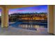 A twilight pool with a water feature and landscaping to create a luxurious and peaceful retreat at 778 Horizon Canyon Dr, Henderson, NV 89052
