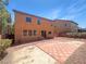 A spacious backyard with a brick patio, perfect for entertaining, with lush landscaping and a neutral-colored home at 8253 Pearl Oasis Ct, Las Vegas, NV 89139