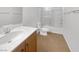 Well-lit bathroom features a sink, toilet, tiled floor, and a shower with glass doors at 8253 Pearl Oasis Ct, Las Vegas, NV 89139