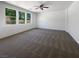 Spacious, carpeted bedroom boasts a ceiling fan and plenty of natural light from the set of three large windows at 8253 Pearl Oasis Ct, Las Vegas, NV 89139