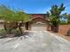 Charming two-story home with a desert landscape, spacious driveway, and a two-car garage, under a clear, bright sky at 8253 Pearl Oasis Ct, Las Vegas, NV 89139