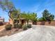 Charming two-story home with a desert landscape, spacious driveway, and a two-car garage, under a clear, bright sky at 8253 Pearl Oasis Ct, Las Vegas, NV 89139