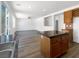 Spacious open-concept kitchen offering wood cabinets, wood floors, stone countertops, and easy access to living areas at 8253 Pearl Oasis Ct, Las Vegas, NV 89139