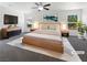 A spacious main bedroom is bathed in natural light, accentuated by modern furniture and a soothing color palette at 8253 Pearl Oasis Ct, Las Vegas, NV 89139