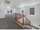 Carpeted staircase and railing leading to a bright and open upstairs living area with abundant natural light at 8253 Pearl Oasis Ct, Las Vegas, NV 89139