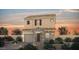 Charming two-story home with stone accents, desert landscaping, and a cozy, inviting facade at sunset at 83 Cashmere Waltz Pl, Henderson, NV 89011