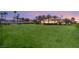 Sprawling green lawn with a full basketball court and unobstructed views of the elegant mansion in the background at 8895 S Tenaya Way, Las Vegas, NV 89113