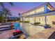 Spectacular backyard showcasing a spacious pool, fire features, covered patio, and travertine pavers, ideal for entertaining at 8895 S Tenaya Way, Las Vegas, NV 89113