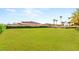 Expansive backyard featuring lush lawn and mature trees, creating a private oasis for outdoor enjoyment at 8895 S Tenaya Way, Las Vegas, NV 89113