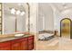 This primary bathroom includes dual vanities, a soaking tub, and separate shower at 8895 S Tenaya Way, Las Vegas, NV 89113
