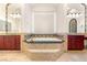 Bathroom offers a soaking tub surrounded by dual vanities and decorative lighting fixtures at 8895 S Tenaya Way, Las Vegas, NV 89113