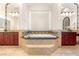 Bathroom offers a soaking tub surrounded by dual vanities and decorative lighting fixtures at 8895 S Tenaya Way, Las Vegas, NV 89113