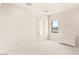 Bright bedroom with neutral carpet, white trim and natural light at 8895 S Tenaya Way, Las Vegas, NV 89113