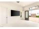 Large, brightly lit bedroom with multiple doors offering outdoor access and neutral finishes at 8895 S Tenaya Way, Las Vegas, NV 89113