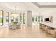 Bright, open-concept living and dining area with stylish chandelier and lots of natural light at 8895 S Tenaya Way, Las Vegas, NV 89113