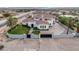 Elegant home showcasing a well-manicured lawn, gated entrance, and sophisticated architectural design at 8895 S Tenaya Way, Las Vegas, NV 89113