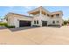 Beautiful home exterior featuring a multi-car garage and a large driveway, surrounded by lush greenery at 8895 S Tenaya Way, Las Vegas, NV 89113
