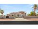 Elegant exterior of a modern home with a gated entrance, manicured landscaping, and a spacious driveway at 8895 S Tenaya Way, Las Vegas, NV 89113