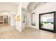 Bright foyer with white walls, wood floors, large windows and arched doorways provide elegant transitions between rooms at 8895 S Tenaya Way, Las Vegas, NV 89113
