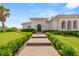 Inviting front yard with lush landscaping and a walkway leading to the elegant home entrance at 8895 S Tenaya Way, Las Vegas, NV 89113
