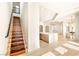 Staircase leading to a modern kitchen and bright dining area at 8895 S Tenaya Way, Las Vegas, NV 89113