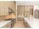 Modern kitchen with sleek cabinetry, a large island, and top-of-the-line stainless steel appliances at 8895 S Tenaya Way, Las Vegas, NV 89113